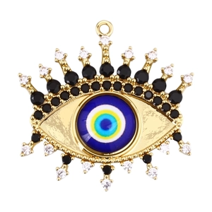 Detailed close-up of golden evil eye pendant with blue crystals and black zircons