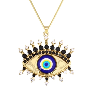 Golden evil eye necklace with blue zircon pendant and sparkling crystal details