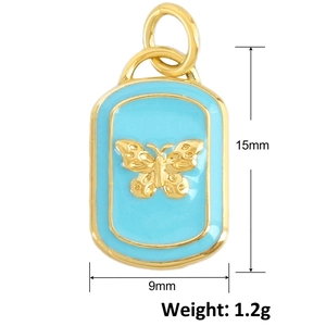 Detailed view of gold butterfly pendant with blue enamel, size 15mm x 9mm and 1.2g weight