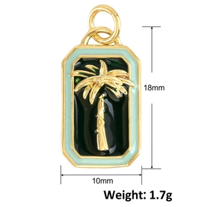 Detailed macro view of gold palm tree pendant with black inlay and mint green enamel border