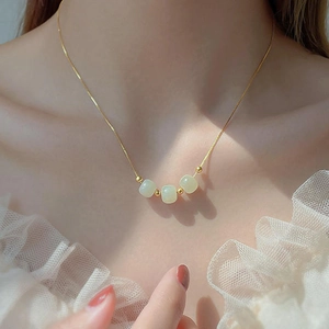 Elegant 18k gold-plated titanium steel necklace featuring three light green jade beads
