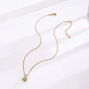 Elegant gold titanium steel necklace with a green jade pendant and crystal rabbit ear design