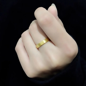 Minimalist 4mm gold titanium steel ring with a brushed matte finish on a finger