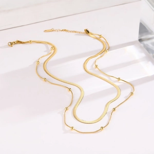 Double-layer gold titanium steel necklace featuring a snake chain and bead choker design