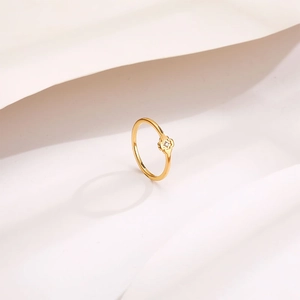 Minimalist gold titanium steel ring with a single diamond flower design and S925 stamp