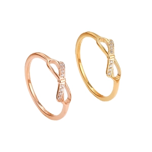 Elegant titanium steel bow ring with sparkling crystals in rose gold and gold finishes