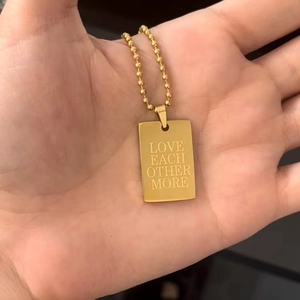 Collana in acciaio inossidabile dorato con pendente rettangolare e incisione a tema