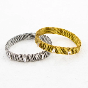 Detail of gold and silver stretch mesh bracelets with inlaid rectangular cubic zirconia