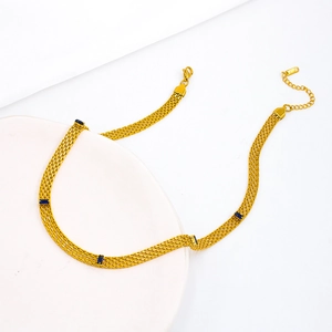 Golden mesh chain necklace with rectangular blue zircons and lobster clasp on white tray