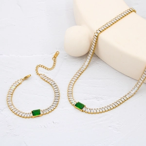 Macro detail of K18 hallmark on gold emerald and baguette zircon jewelry set