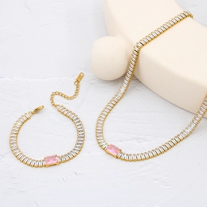 Detailed close-up of 18K gold plated jewelry set with pink and white cubic zirconia stones