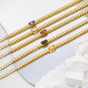 Macro shot of gold stainless steel tennis necklaces with colorful zircon center stones