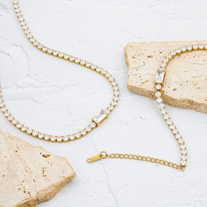 Gold plated tennis necklace with cubic zirconia stones and emerald cut center pendant