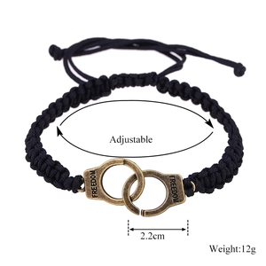 Detail view of woven bracelet with bronze freedom handcuffs and adjustable strap size