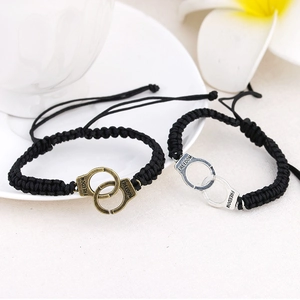 Handmade woven couple bracelets with metal handcuffs charms and Freedom engraving