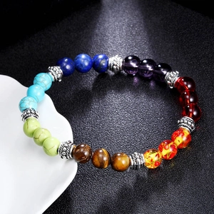 Macro shot of colorful seven chakra lava stone beads with antique silver spacer beads