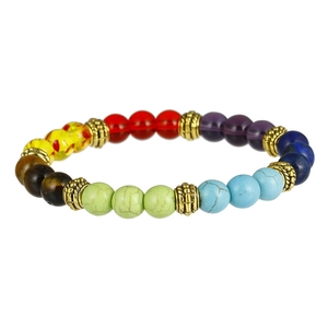 Detail of 7 chakra beads bracelet with tiger eye stones and golden metal spacers