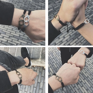Handmade woven handcuffs bracelet for couples featuring freedom engraving in two metal tones