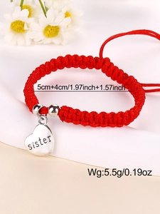 Detail of red handmade braided sister bracelet with heart pendant and size dimensions