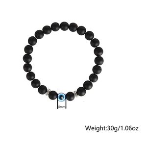 Detail shot of 8mm matte black beads with a blue evil eye stone and silver spacers