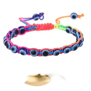 Handmade woven rainbow evil eye bracelet with colorful beads and adjustable cord