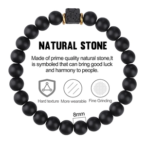 Detail of 8mm matte black natural stone beads with a square volcanic rock and gold spacers