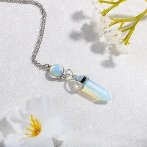 Close-up of opalite hexagonal prism pendant necklace on a white textured background