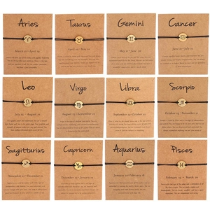 Set of 12 zodiac handmade woven bracelets with golden charms on kraft display cards