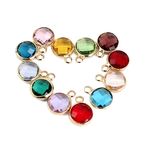 Colorful faceted birthstone crystal pendants arranged in a heart shape with gold rims