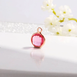 Detail view of pink faceted crystal pendant in rose gold frame for DIY jewelry