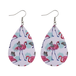 Detailed close-up of teardrop faux leather earrings with flamingo and butterfly prints