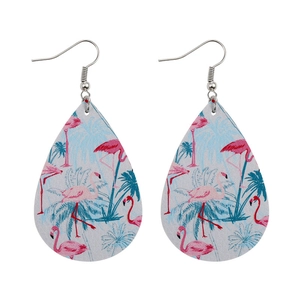 Detail of teardrop leather earrings featuring pink flamingo and palm leaf tropical patterns
