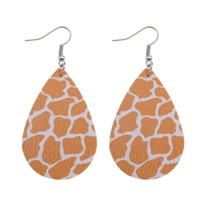Detail of teardrop faux leather earrings with brown giraffe print and silver hooks