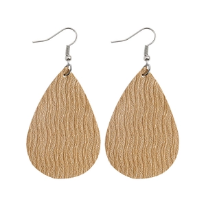 Detail shot of teardrop faux leather earrings with golden wave texture and silver hooks