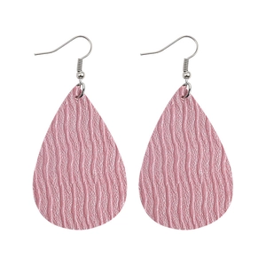 Close-up of pink teardrop faux leather earrings with wavy texture and silver hooks