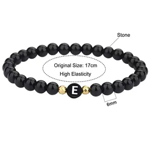 Gepolijste zwarte agaat armband met 6mm kralen, letter E en gouden accenten