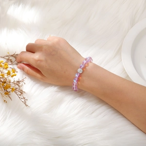 Detail of lavender moonstone beaded bracelet with pave crystal charm worn on wrist