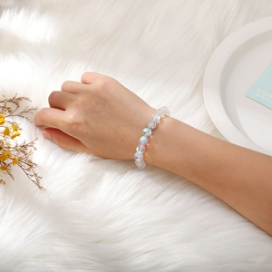 Detailed view of iridescent moonstone beaded bracelet with shimmering silver center bead