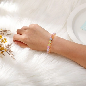 Detail of frosted moonstone beaded bracelet with a sparkling crystal pave charm ball