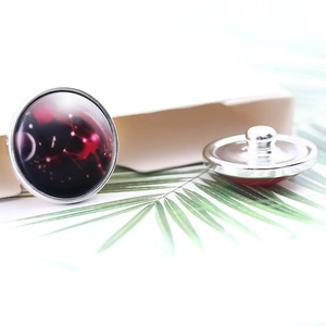 Detail of 20mm Virgo zodiac glass snap button with nebula design and silver metal base