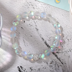 Macro view of frosted aurora beads with a sparkling rhinestone-paved metal accent ball