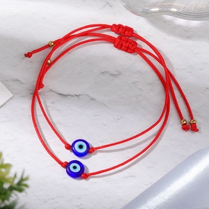 Handmade red braided Evil Eye bracelets with blue glass beads and adjustable cord