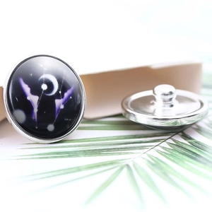 Detailed close-up of 20mm silver constellation buttons with glass dome and moon star design