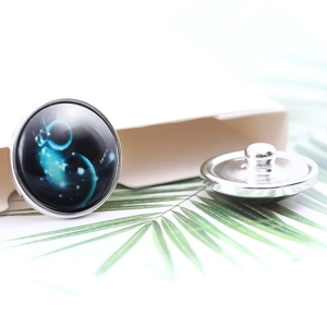 Detailed view of silver snap buttons with blue nebula patterns and back structure