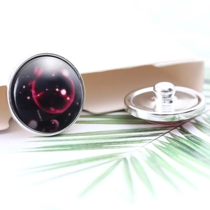 Macro shot of 20mm galaxy glass snap buttons with silver metal base for jewelry