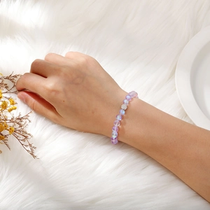 Detailed view of aurora iridescent 8mm beads bracelet with sparkling zircon spacer on wrist