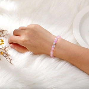 Detailed view of iridescent pink moonstone beads bracelet with a sparkling silver centerpiece