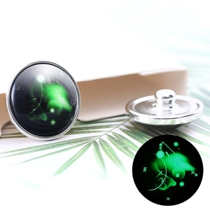 Macro detail of 20mm luminous nebula constellation button with glow-in-the-dark effect