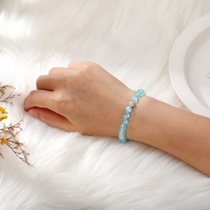 Close-up of 8mm light blue frosted moonstone elastic bracelet with a sparkling silver bead
