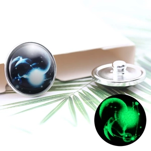 Detailed view of luminous 20mm constellation glass button with glowing green night effect